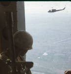 Soldier looking out from a UH-1 "Huey" helicopter in Vietnam, 1967-1968